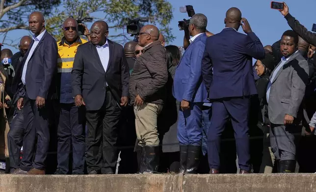 South African President Cyril Ramaphosa, third left, with his officials, visit the flood-affected areas in Mthatha, South Africa, Friday, June 13, 2025. (AP Photo/Themba Hadebe)