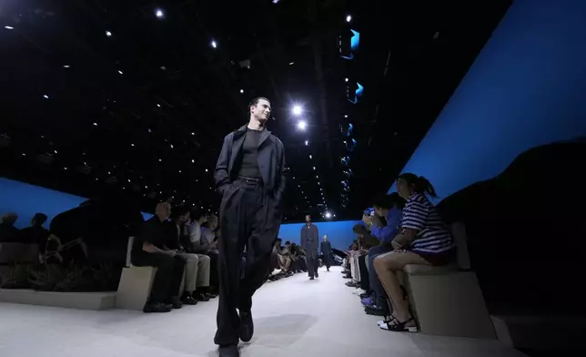 A model wears a creation as part of the men's Giorgio Armani Spring-Summer 2026 collection, that was presented in Milan, Italy, Monday, June 23, 2025. (AP Photo/Luca Bruno)