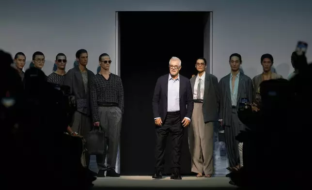 Leo Dell'Orco, centre, accepts applause after the men's Giorgio Armani Spring-Summer 2026 collection, that was presented in Milan, Italy, Monday, June 23, 2025. (AP Photo/Luca Bruno)