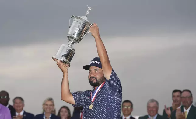 J.J. Spaun celebrates with the trophy after winning the U.S. Open golf tournament at Oakmont Country Club Sunday, June 15, 2025, in Oakmont, Pa. (AP Photo/Seth Wenig)