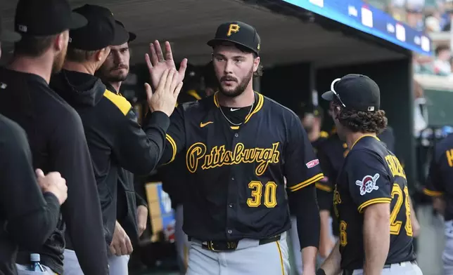 Pittsburgh Pirates pitcher Paul Skenes (30) high fives teammates after the sixth inning against the Detroit Tigers during the second baseball game of a doubleheader, Thursday, June 19, 2025, in Detroit. (AP Photo/Paul Sancya)