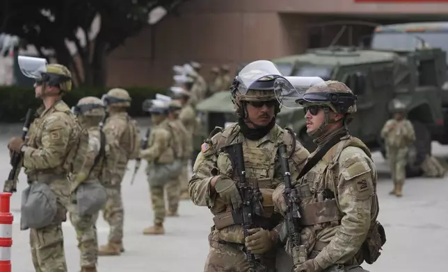 U.S. National Guard are deployed outside the federal prison in downtown Los Angeles, Sunday, June 8, 2025, following a immigration raid protest the night before. (AP Photo/Jae Hong)