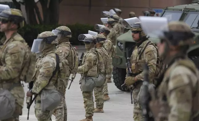 U.S. National Guard are deployed outside the federal prison in downtown Los Angeles, Sunday, June 8, 2025, following a immigration raid protest the night before. (AP Photo/Jae Hong)