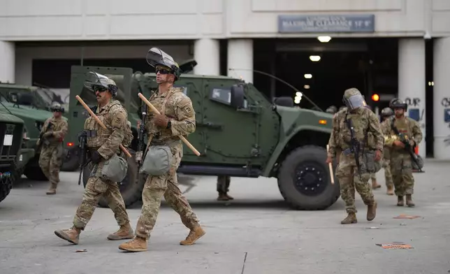 U.S. National Guard are deployed around downtown Los Angeles, Sunday, June 8, 2025, following an immigration raid protest the night before. (AP Photo/Eric Thayer)