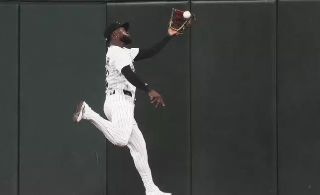 Chicago White Sox center fielder Luis Robert Jr. catches a fly ball hit by Arizona Diamondbacks' Jose Herrera during the seventh inning of a baseball game in Chicago, Tuesday, June 24, 2025. (AP Photo/Nam Y. Huh)