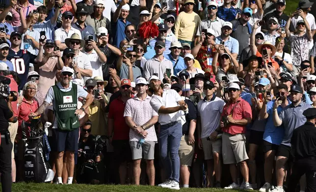 Tommy Fleetwood, from England, hits his second shot on the 15th hole during the final round of the Travelers Championship golf tournament at TPC River Highlands, Sunday, June 22, 2025, in Cromwell, Conn. (AP Photo/Jessica Hill)