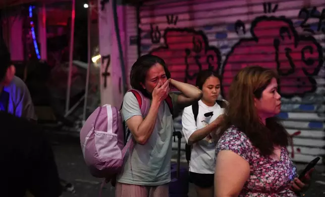 People evacuate after a missile launched from Iran struck Tel Aviv, Israel, Monday June 16, 2025. (AP Photo/Baz Ratner)