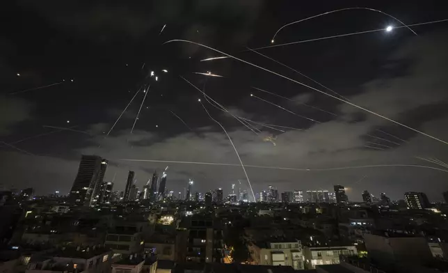 The Israeli Iron Dome air defense system fires to intercept missiles during an Iranian attack over Tel Aviv, Israel, Sunday, June 15, 2025. (AP Photo/Leo Correa)