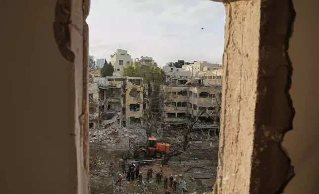 Rescue team work at the site where a missile launched from Iran struck Tel Aviv, Israel, Monday, June 16, 2025. (AP Photo/Baz Ratner)