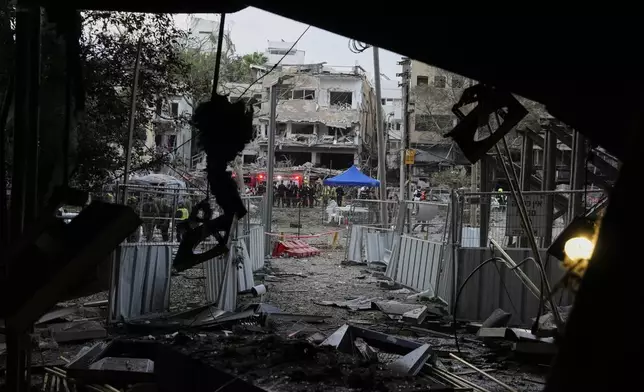 Rescue team work at the site where a missile launched from Iran struck Tel Aviv, Israel, Monday, June 16, 2025. (AP Photo/Baz Ratner)