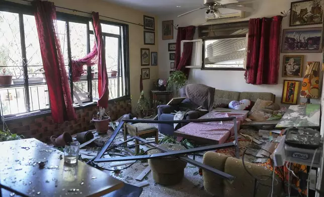 A damaged apartment is seen near the site where an Iranian missile struck in Haifa, Israel, Monday, June 16, 2025. (AP Photo/Ariel Schalit)