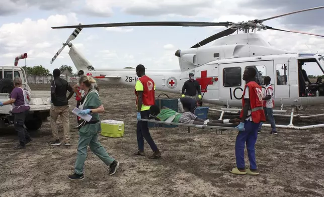 Medical staff with the International Committee of the Red Cross (ICRC) and South Sudan Red Cross, move a weapon-wounded patient to an ambulance in Akobo, South Sudan, Saturday, May 24, 2025. (AP Photo/Joseph Falzetta)