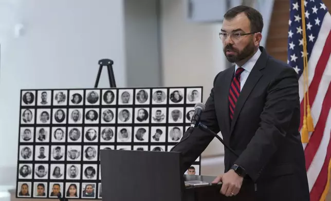 Photos of victims are displayed as U.S. Attorney for the Western District of Texas Justin Simmons holds a news conference following the the sentence hearing for Felipe Orduna-Torres and Armando Gonzales-Ortega, smugglers connected to an operation that led to the deaths of 53 migrants in the back of a tractor-trailer, Friday, June 27, 2025, in San Antonio. (AP Photo/Eric Gay)