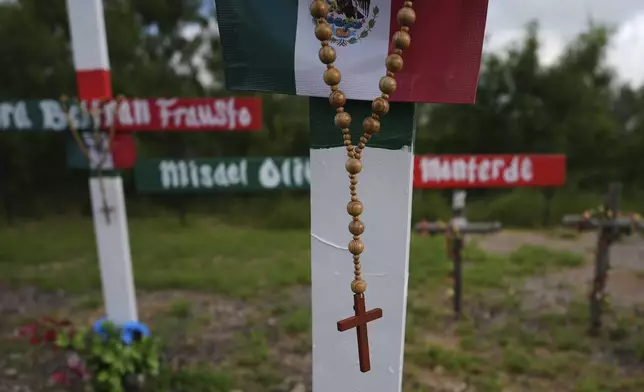 Crosses stand at a memorial honoring the victims and survivors of a human smuggling tragedy where dozens of migrants were found in an airless tractor-trailer rig two years ago, in San Antonio, Friday, June 27, 2025. (AP Photo/Eric Gay)