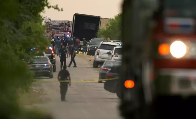 FILE - Body bags lie at the scene where a tractor trailer with multiple dead bodies was discovered, Monday, June 27, 2022, in San Antonio. (AP Photo/Eric Gay,File)