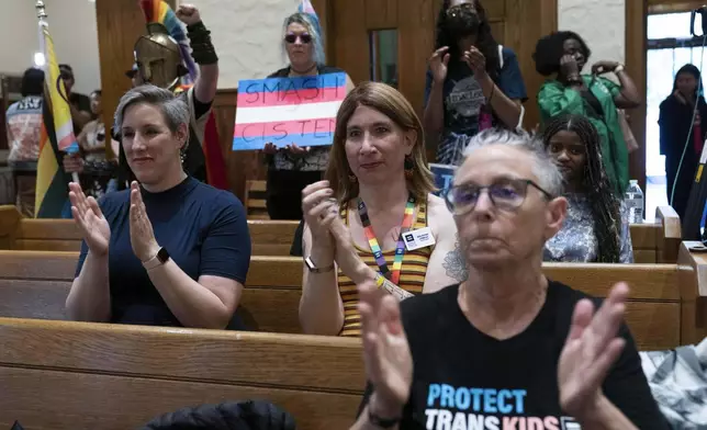 Transgender rights supporters rally at the Lutheran Church of the Reformation on Capitol Hill, Wednesday, June 18, 2025, in Washington after the Supreme Court upheld Tennessee's ban on gender-affirming care for transgender minors, in a setback to transgender rights. (AP Photo/Jose Luis Magana)