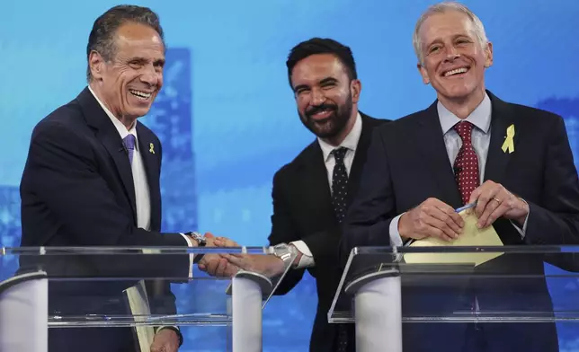 Democratic mayoral candidates Andrew Cuomo, left, shakes hands with Zohran Mamdani, center, as Whitney Tilson reacts after participating in a Democratic mayoral primary debate, Wednesday, June 4, 2025, in New York. (AP Photo/Yuki Iwamura, Pool)