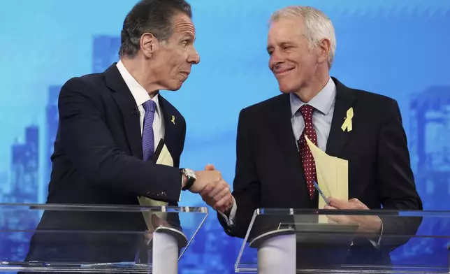 Democratic mayoral candidates Andrew Cuomo and Whitney Tilson shake hands after participating in a Democratic mayoral primary debate, Wednesday, June 4, 2025, in New York. (AP Photo/Yuki Iwamura, Pool)