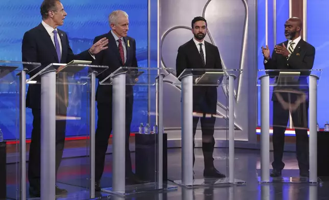 Democratic mayoral candidates Andrew Cuomo, far left, and Michael Blake present arguments as Whitney Tilson, second from left, and Zohran Mamdani look on during a Democratic mayoral primary debate, Wednesday, June 4, 2025, in New York. (AP Photo/Yuki Iwamura, Pool)