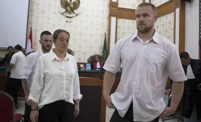 British nationals, from left, Jonathan Collyer, Lisa Stocker, and Phineas Float who are accused of smuggling nearly a kilogram (over two pounds) of cocaine into Indonesia leave the courtroom after their first trial hearing at Denpasar District Court in Denpasar, Bali, on Tuesday, June 3, 2025. (AP Photo/Firdia Lisnawati)