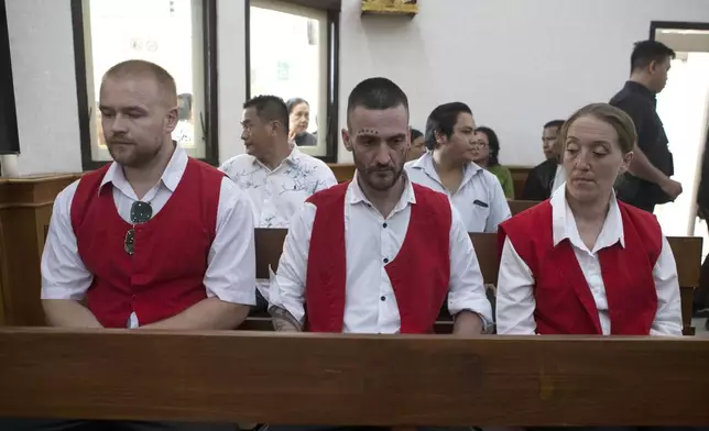 British nationals, from left, Phineas Float, Jonathan Collyer, and Lisa Stocker who are accused of smuggling nearly a kilogram (over two pounds) of cocaine into Indonesia sit inside the courtroom before the start of their trial hearing at Denpasar District Court in Denpasar, Bali, on Tuesday, June 3, 2025. (AP Photo/Firdia Lisnawati)