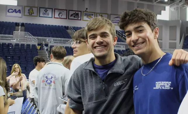 Twin brothers Chase Herzog, left, and Derek Herzog attend rehearsal for Plainview-Old Bethpage John F. Kennedy High School's graduation ceremony at Hofstra University in Hempstead, N.Y., on Tuesday, June 17, 2025. (AP Photo/Philip Marcelo)