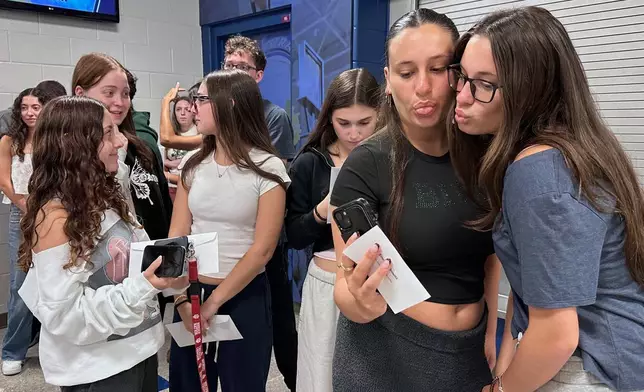Twin sisters Emma Leibowitz, left, and Kayla Leibowitz attend rehearsal for Plainview-Old Bethpage John F. Kennedy High School's graduation ceremony at Hofstra University in Hempstead, N.Y., on Tuesday, June 17, 2025. (AP Photo/Philip Marcelo)