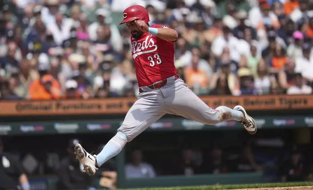 Cincinnati Reds' Christian Encarnacion-Strand scores on a Detroit Tigers pitcher Will Vest wild pitch in the eighth inning during a baseball game, Sunday, June 15, 2025, in Detroit. (AP Photo/Paul Sancya)