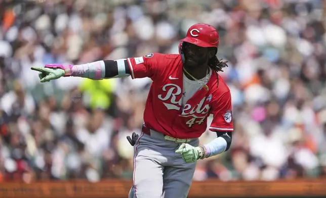 Cincinnati Reds' Elly De La Cruz points to the dugout after hitting a one-run single against the Detroit Tigers in the eighth inning during a baseball game, Sunday, June 15, 2025, in Detroit. (AP Photo/Paul Sancya)