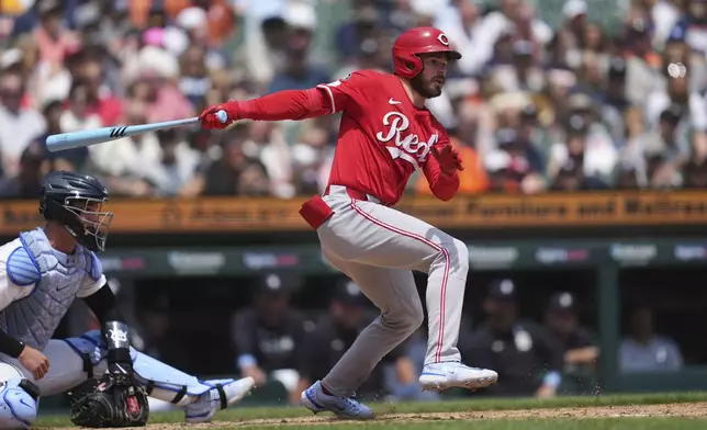 Cincinnati Reds' Gavin Lux hits a one-run single against the Detroit Tigers in the eighth inning during a baseball game, Sunday, June 15, 2025, in Detroit. (AP Photo/Paul Sancya)