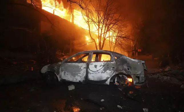 Firefighters tackle a blaze after a Russian attack that hit a residential building in Kharkiv, Ukraine, Wednesday, June 11, 2025. (AP Photo/Andrii Marienko)