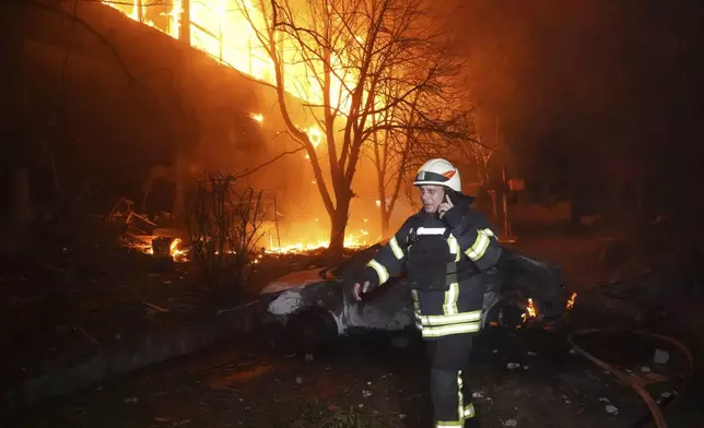 Firefighters tackle a blaze after a Russian attack that hit a residential building in Kharkiv, Ukraine, Wednesday, June 11, 2025. (AP Photo/Andrii Marienko)