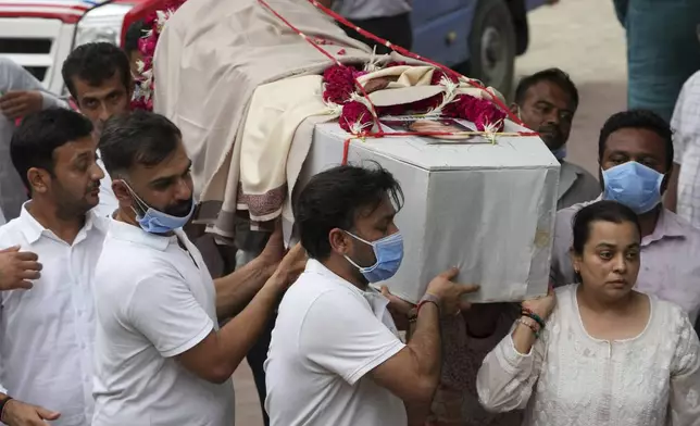 Family members carry coffin of Meena Patel, victim of the Air India plane crash, during his cremation at a crematorium in Ahmedabad, India, Monday, June 16, 2025. (AP Photo/Ajit Solanki)
