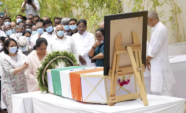 Anjali Rupani, second left, wife of former Chief Minister of Gujarat Vijay Rupani, victim of Thursday's Air India plane crash, pays respect after receiving his body at a hospital in Ahmedabad, India, Monday, June 16, 2025. (AP Photo/Ajit Solanki)