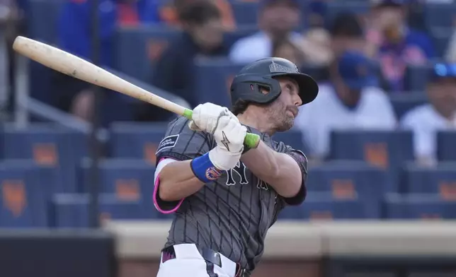 New York Mets' Jeff McNeil follows through on a home run during the eighth inning of a baseball game against the Colorado Rockies Saturday, May 31, 2025, in New York. (AP Photo/Frank Franklin II)