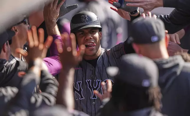 New York Mets' Juan Soto celebrates with teammates after hitting a home run during the fourth inning of a baseball game against the Colorado Rockies Saturday, May 31, 2025, in New York. (AP Photo/Frank Franklin II)