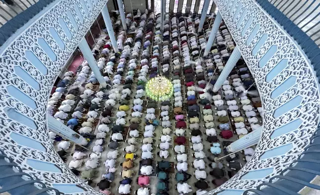 Devotees pray during the Muslim festival of Eid al-Adha at Baitul Mukarram National Mosque in Dhaka, Bangladesh, Saturday, June 7, 2025. (AP Photo/Mahmud Hossain Opu)