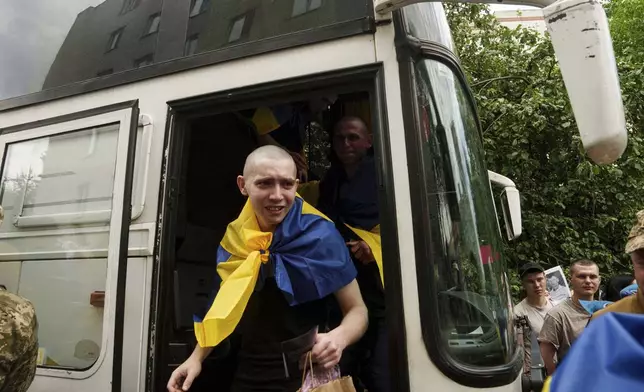 An Ukrainian soldier reacts after returning from captivity after a POWs exchange between Russia and Ukraine, in Chernyhiv region, Ukraine, Monday, June 9, 2025. (AP Photo/Evgeniy Maloletka)