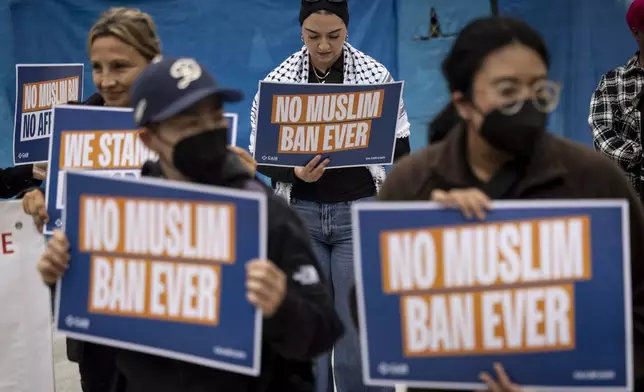 Demonstrators gather during a protest against the new travel ban announced last week by President Donald Trump, at the Tom Bradley International Terminal at Los Angeles International Airport, Monday, June 9, 2025, in Los Angeles. (AP Photo/Etienne Laurent)
