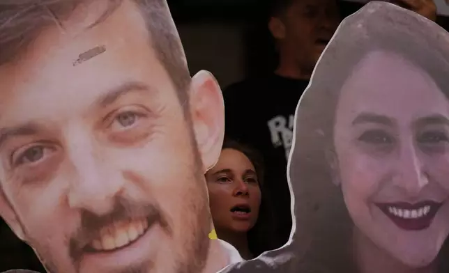 Relatives and supporters of Israeli hostages held by Hamas in Gaza hold photos depicting the faces of Israeli hostages who are being held in the Gaza Strip, during a protest demanding their release from Hamas captivity, in Tel Aviv, Israel, Monday, June 9, 2025. (AP Photo/Ariel Schalit)