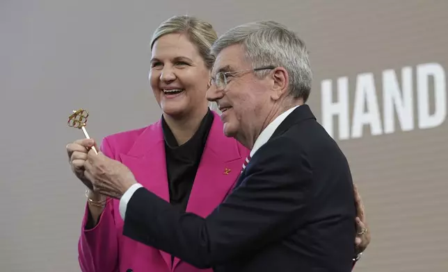 IOC President Thomas Bach, right, and President-elect Kirsty Coventry pose during the handover ceremony of the IOC Presidency at Olympic House in Lausanne, Switzerland, Monday, June 23, 2025. (AP Photo/Laurent Cipriani)