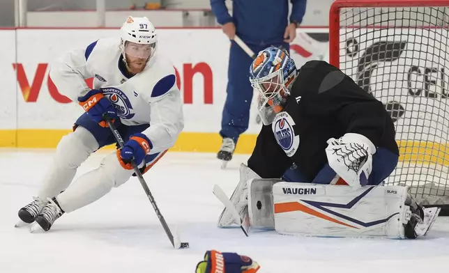 Edmonton Oilers forward Connor McDavid (97) tries to score on Edmonton Oilers goaltender Calvin Pickard during practice at the NHL Stanley Cup Finals in Fort Lauderdale, Fla., Tuesday, June 10, 2025.(Nathan Denette/The Canadian Press via AP)