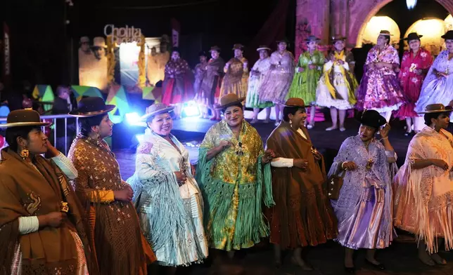 Women compete in the Miss Cholita Pacena beauty pageant, an annual contest aiming to recognize Aymara Indigenous women's fashion and beauty, as well as their command of the Indigenous lifestyle and language, in La Paz, Bolivia, Friday, June 27, 2025. (AP Photo/Juan Karita)