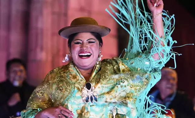 Teresa Marisol Mayta celebrates after winning the Miss Cholita Pacena beauty pageant, an annual contest aiming to recognize Aymara Indigenous women's fashion and beauty, as well as their command of the Indigenous lifestyle and language, in La Paz, Bolivia, Friday, June 27, 2025. (AP Photo/Juan Karita)