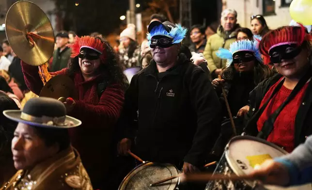People cheer for contestants during the Miss Cholita Pacena beauty pageant, an annual contest aiming to recognize Aymara Indigenous women's fashion and beauty, as well as their command of the Indigenous lifestyle and language, in La Paz, Bolivia, Friday, June 27, 2025. (AP Photo/Juan Karita)