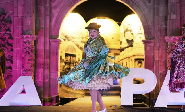 Teresa Marisol Mayta competes in the Miss Cholita Pacena beauty pageant, an annual contest aiming to recognize Aymara Indigenous women's fashion and beauty, as well as their command of the Indigenous lifestyle and language, in La Paz, Bolivia, Friday, June 27, 2025. (AP Photo/Juan Karita)