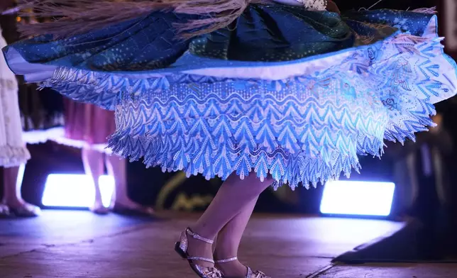 A woman competes in the Miss Cholita Pacena beauty pageant, an annual contest aiming to recognize Aymara Indigenous women's fashion and beauty, as well as their command of the Indigenous lifestyle and language, in La Paz, Bolivia, Friday, June 27, 2025. (AP Photo/Juan Karita)