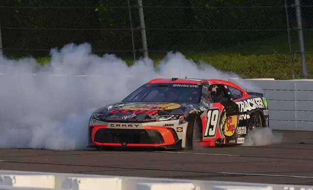 Chase Briscoe celebrates with a burnout after winning a NASCAR Cup Series auto race at Pocono Raceway, Sunday, June 22, 2025, in Long Pond, Pa. (AP Photo/Derik Hamilton)