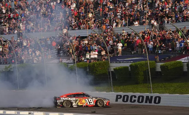 Chase Briscoe celebrates with a burnout after winning a NASCAR Cup Series auto race at Pocono Raceway, Sunday, June 22, 2025, in Long Pond, Pa. (AP Photo/Derik Hamilton)