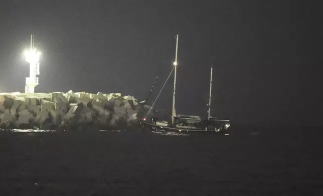 The Gaza-bound aid boat, Madleen, under escort of Israeli naval forces enters to Ashdod Port in southern Israel after being seized by Israeli forces, Monday, June 9, 2025. (AP Photo/Leo Correa)